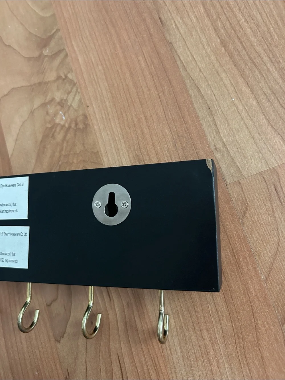Black Wall Hook Rack with Gold Script Lettering